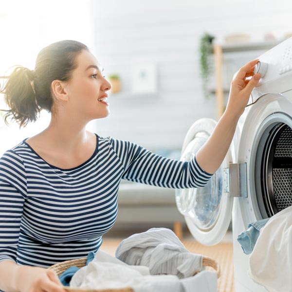 woman changing setting on dryer