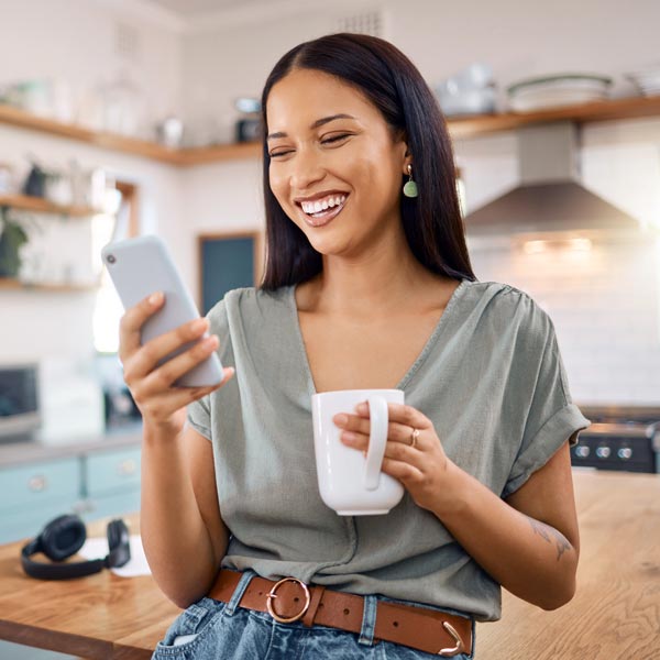 woman in kitchen making appointment on phone